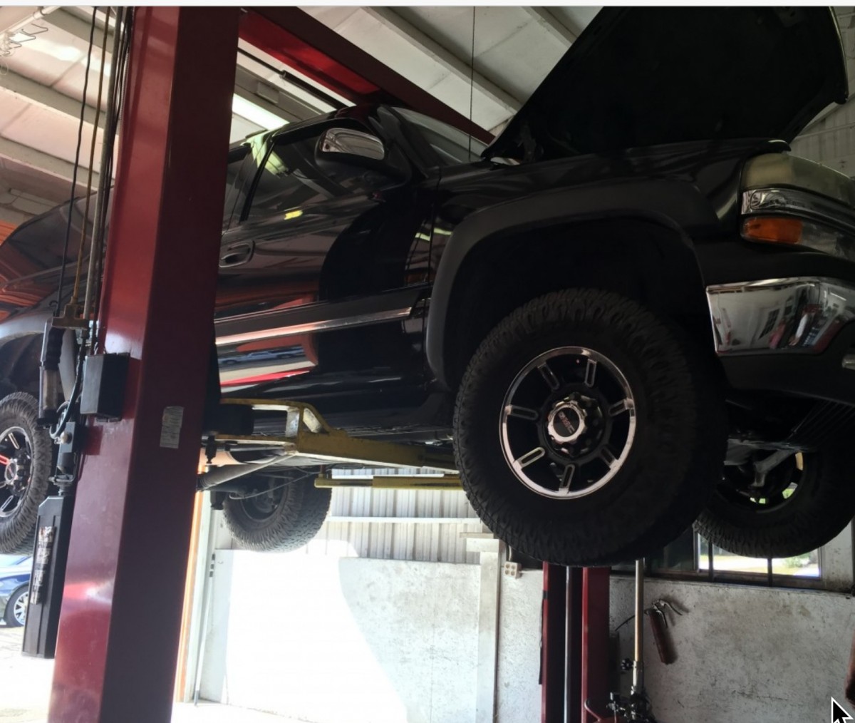 working on a truck on a lift