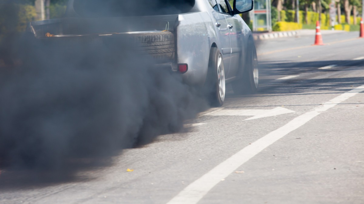 exhaust coming from a muffler of a truck on the road