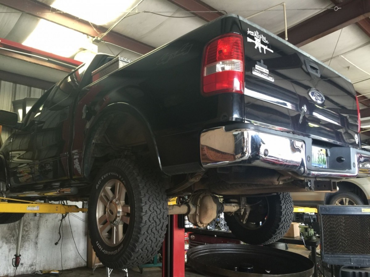 truck on lift in shop 